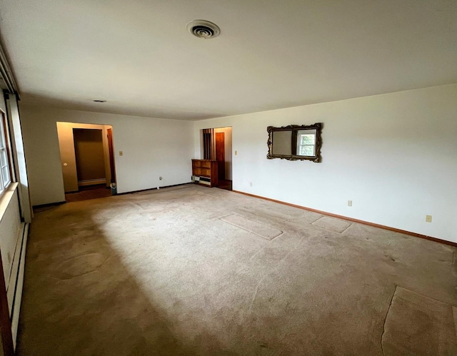 empty room with carpet flooring and a baseboard radiator