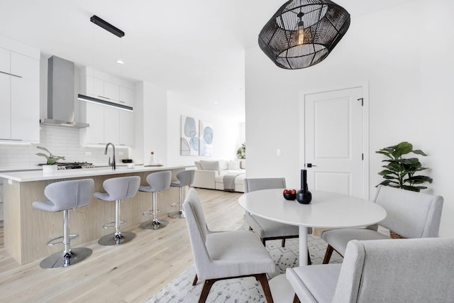 dining area featuring light hardwood / wood-style flooring and sink