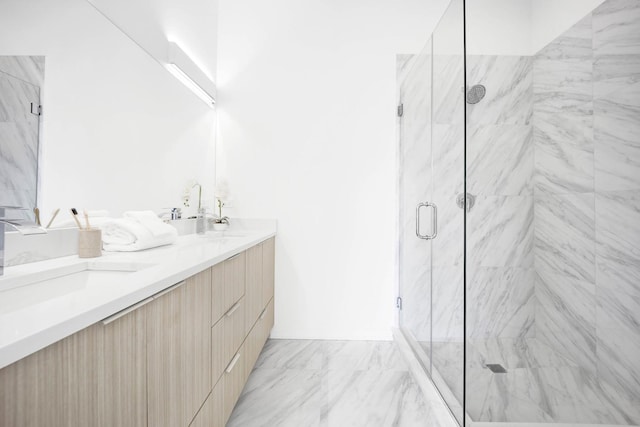 bathroom featuring vanity and a shower with shower door