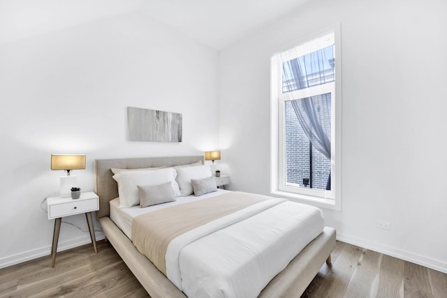 bedroom with hardwood / wood-style floors