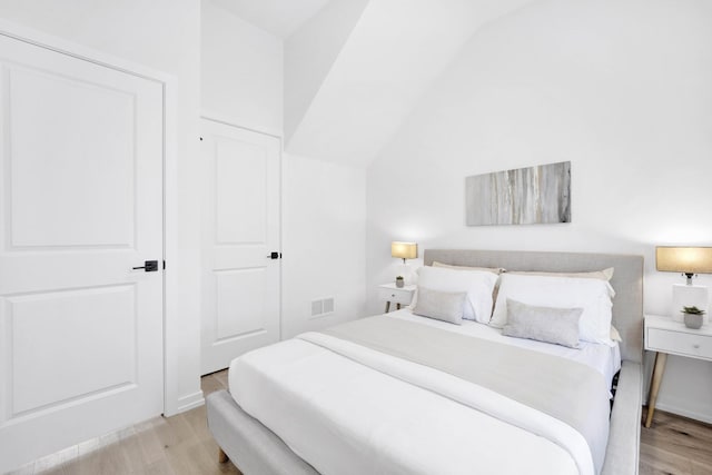 bedroom featuring light hardwood / wood-style floors and a closet