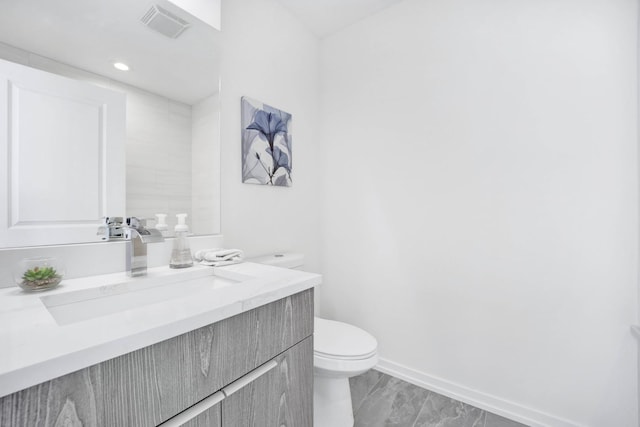 bathroom featuring vanity and toilet