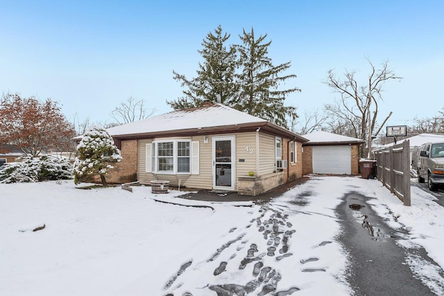 view of front of home with a garage and an outdoor structure