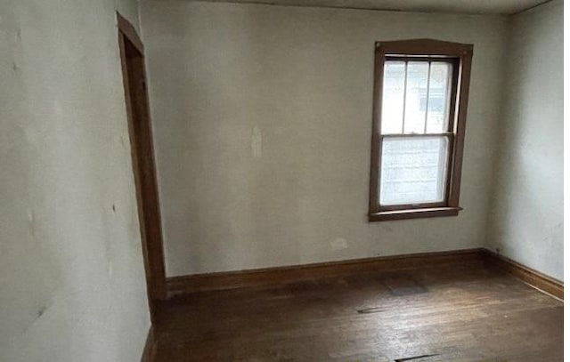 spare room featuring dark hardwood / wood-style flooring