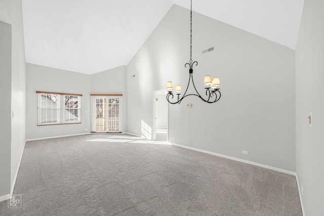 unfurnished living room with high vaulted ceiling, carpet floors, and a chandelier