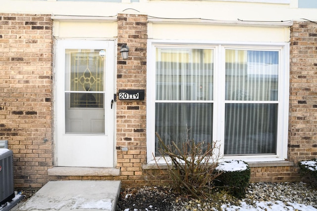 doorway to property with central AC unit