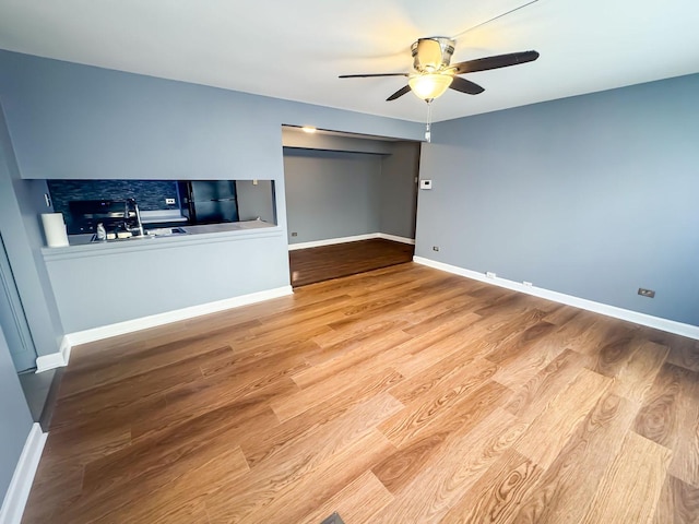 interior space with ceiling fan and light hardwood / wood-style floors