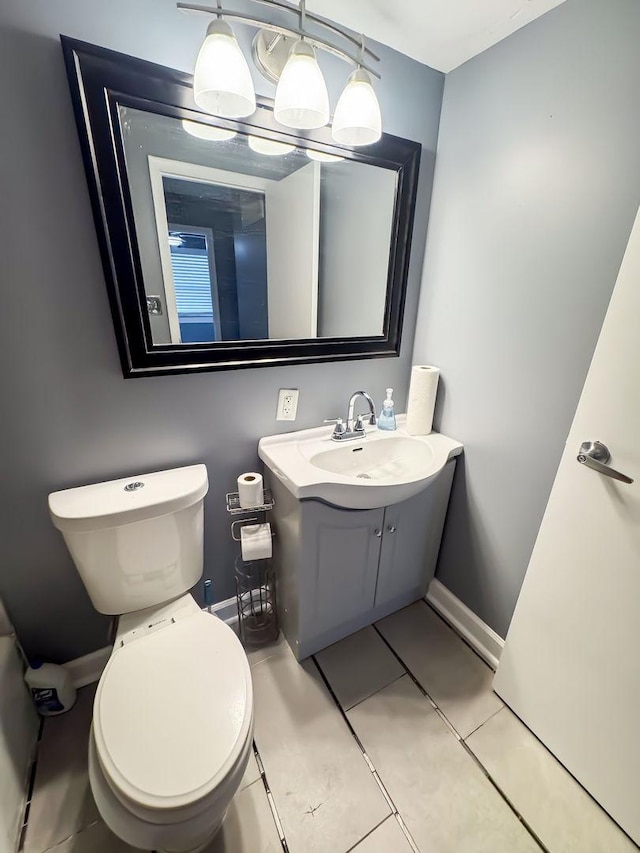 bathroom with tile patterned flooring, vanity, and toilet