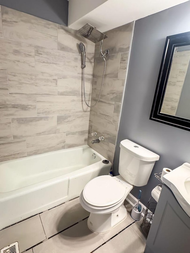 full bathroom with tiled shower / bath, tile patterned flooring, vanity, and toilet