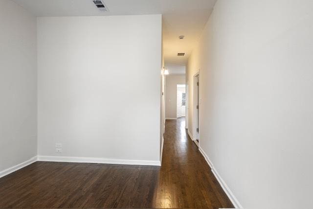 hallway featuring dark hardwood / wood-style flooring