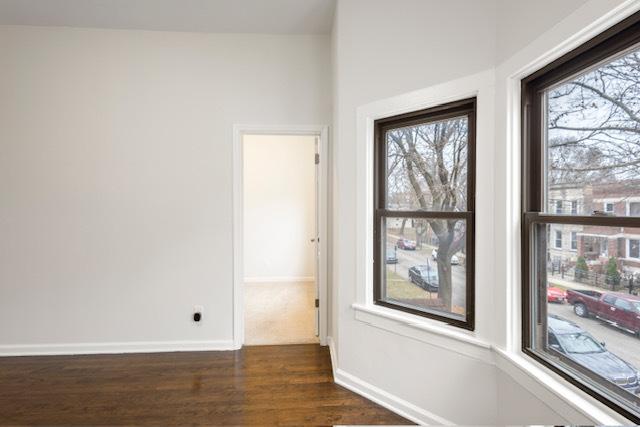 empty room with dark hardwood / wood-style floors