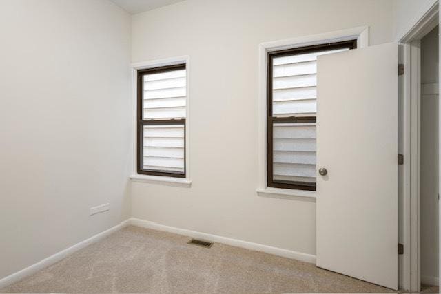 unfurnished room with light carpet