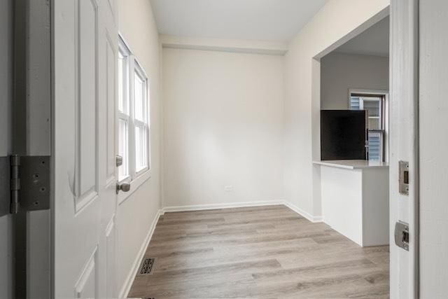 spare room featuring light hardwood / wood-style floors