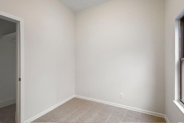 spare room with light carpet