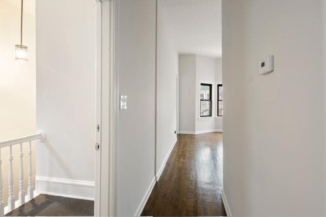 hallway with dark wood-type flooring