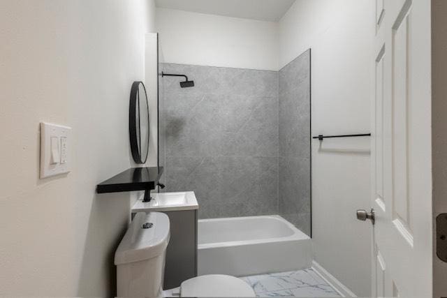 full bathroom featuring tiled shower / bath, vanity, and toilet