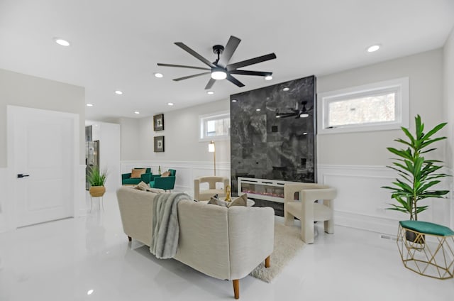 living room featuring ceiling fan and a healthy amount of sunlight