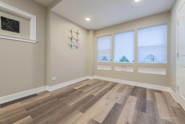 spare room with hardwood / wood-style floors