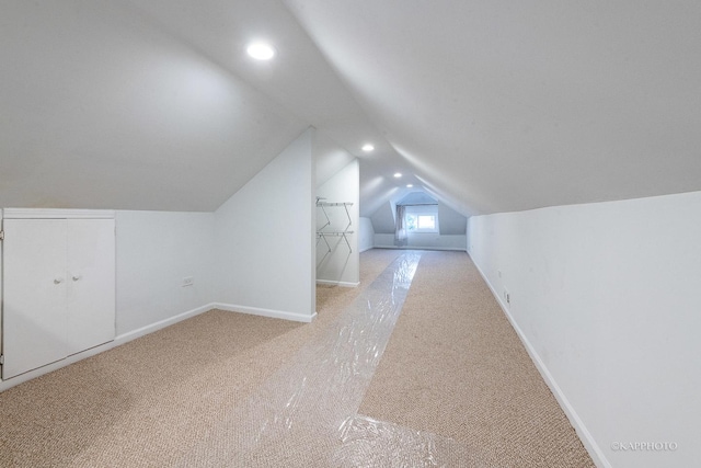 bonus room featuring light carpet and lofted ceiling