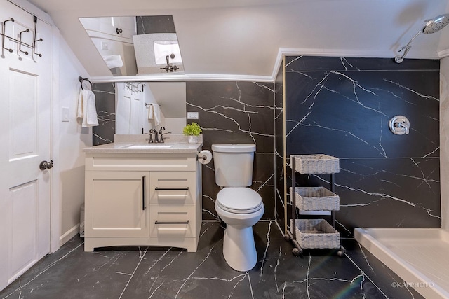 bathroom featuring vanity, toilet, walk in shower, and tile walls