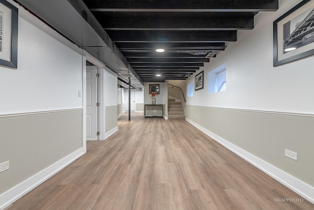 basement with light hardwood / wood-style flooring