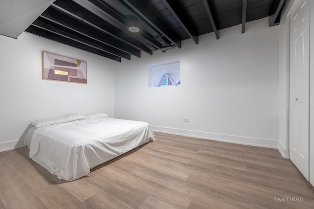 bedroom with hardwood / wood-style flooring, wood ceiling, and beamed ceiling