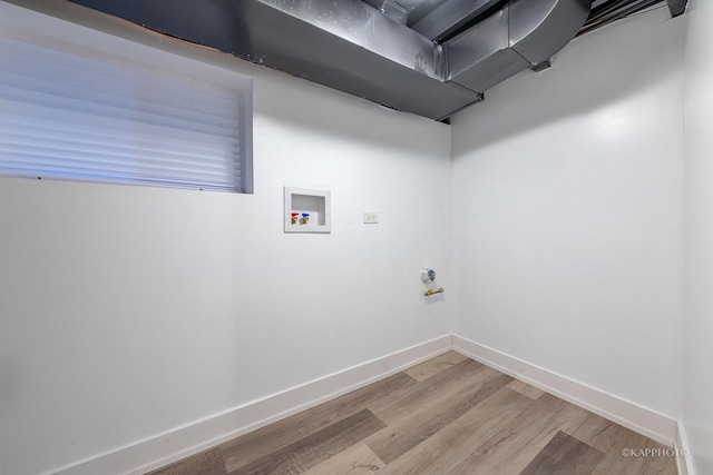 clothes washing area featuring hookup for a washing machine and light hardwood / wood-style flooring