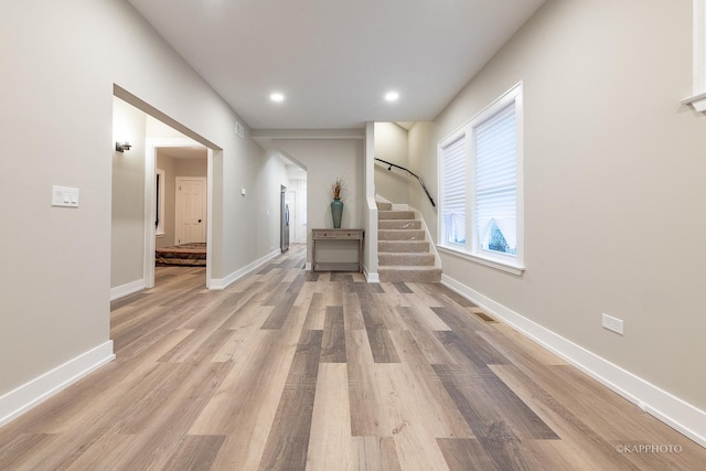 unfurnished living room with light hardwood / wood-style flooring