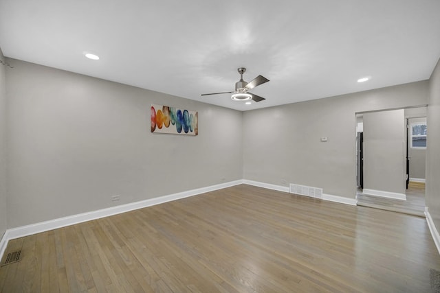 empty room featuring ceiling fan and light hardwood / wood-style flooring