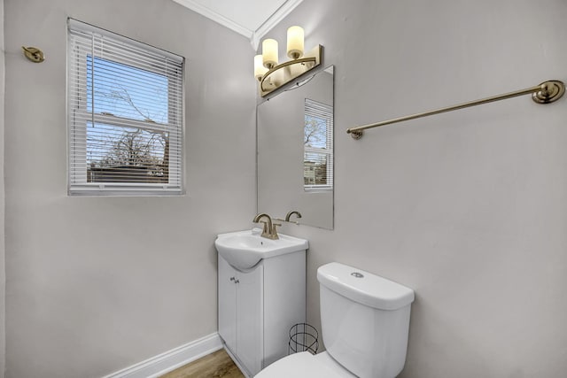 bathroom with vanity, toilet, and crown molding