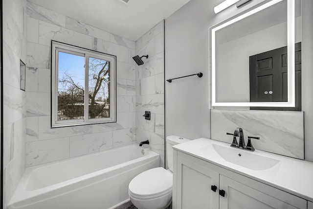 full bathroom featuring vanity, toilet, and tiled shower / bath