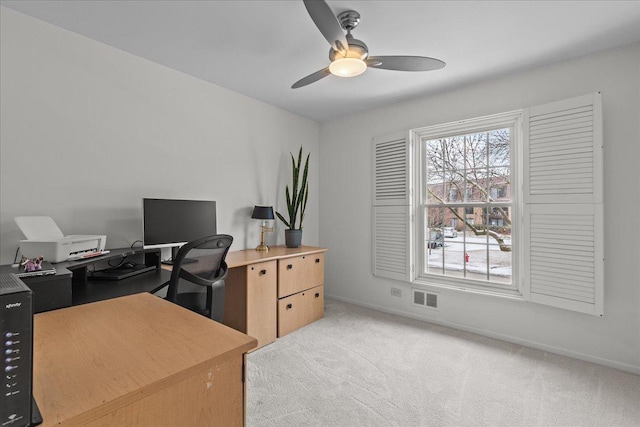 office space with light colored carpet and ceiling fan