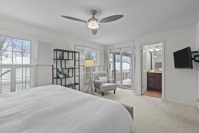 carpeted bedroom featuring multiple windows, connected bathroom, access to outside, and ceiling fan