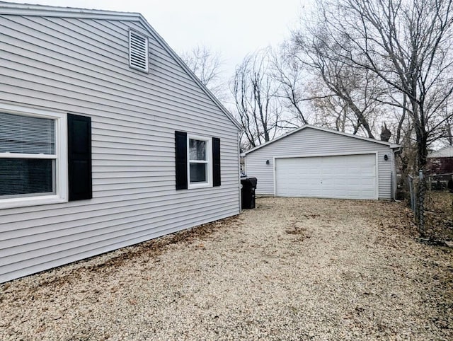 view of side of property with an outdoor structure and a garage