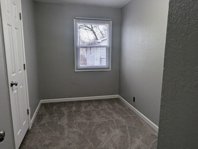 empty room with dark carpet