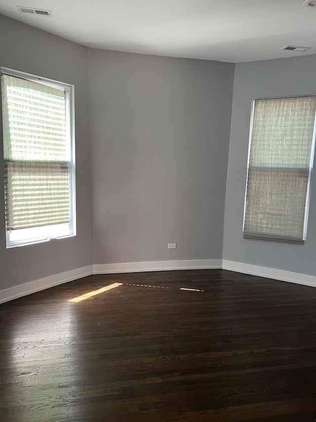 spare room with wood finished floors