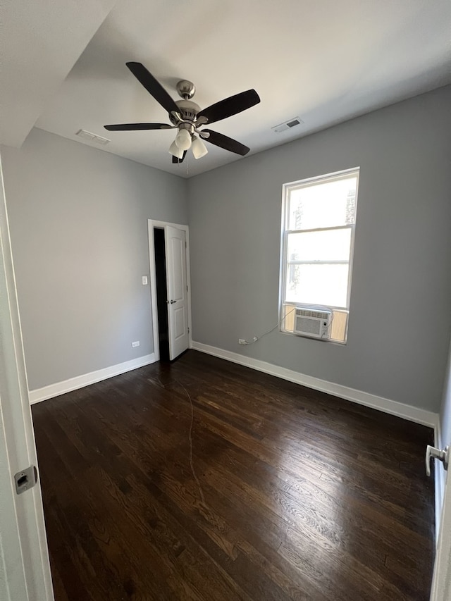 unfurnished room featuring dark wood-style floors, a ceiling fan, and cooling unit