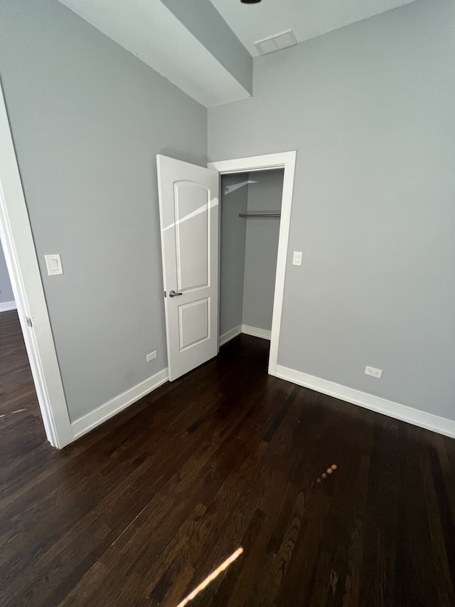 unfurnished bedroom featuring wood finished floors and a closet