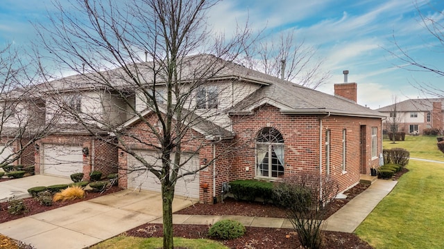 view of front of property featuring a front lawn and a garage