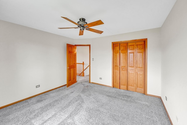 unfurnished bedroom featuring ceiling fan, light carpet, and a closet