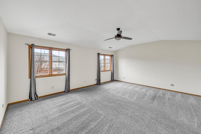 carpeted empty room featuring ceiling fan and vaulted ceiling