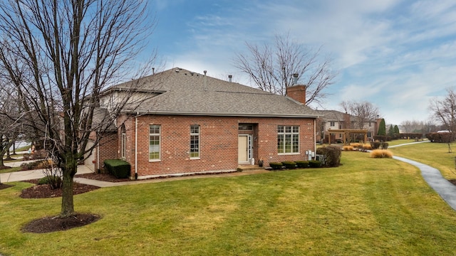 rear view of property featuring a yard