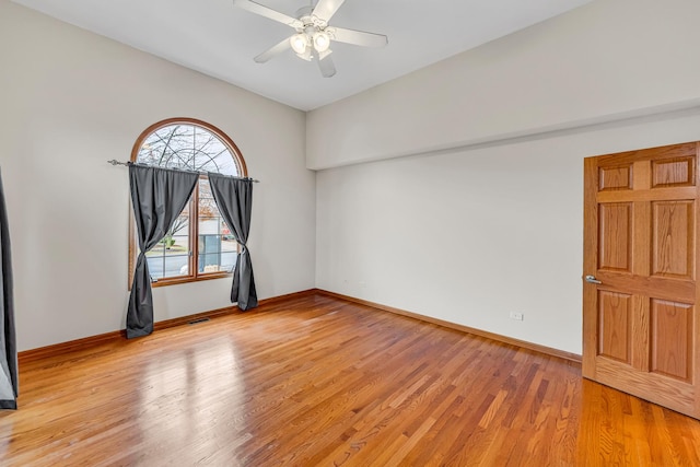 spare room with ceiling fan and light wood-type flooring