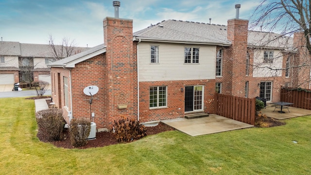 back of property with a patio and a lawn