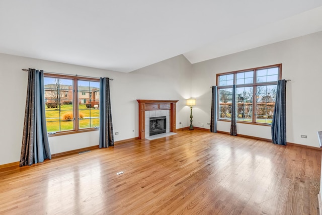 unfurnished living room featuring light wood-type flooring and a fireplace