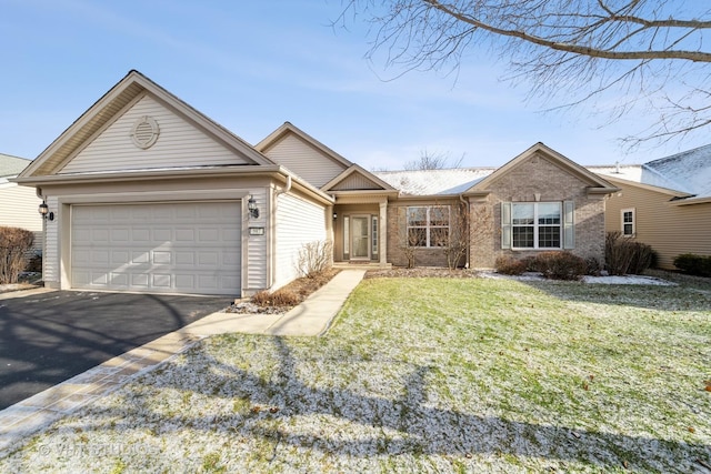 ranch-style home with a front yard and a garage