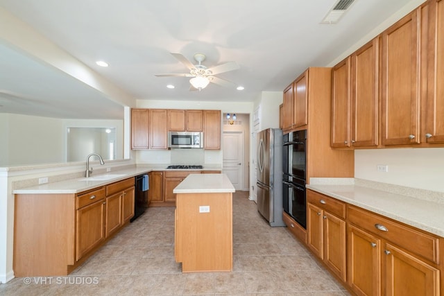 kitchen featuring a center island, black appliances, sink, ceiling fan, and kitchen peninsula