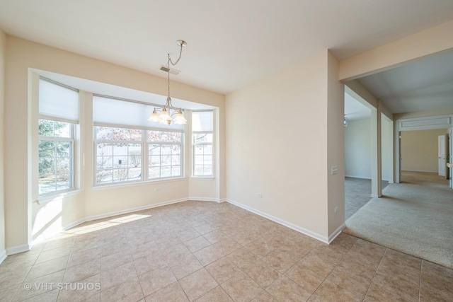 unfurnished room featuring a notable chandelier and light tile patterned floors