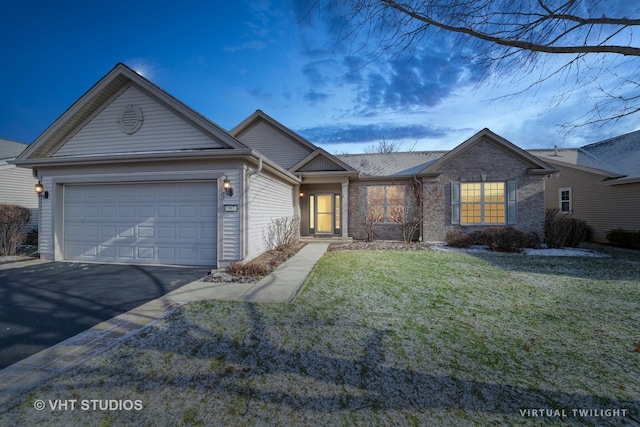 single story home featuring a lawn and a garage