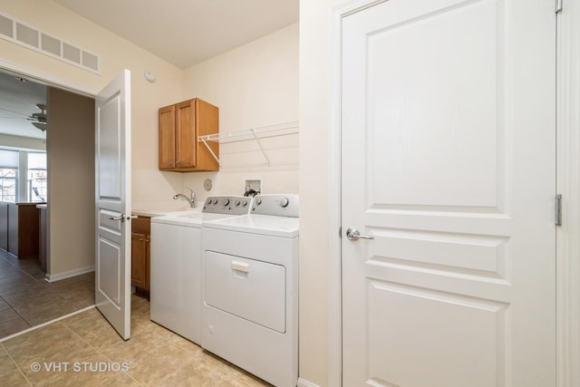 laundry room featuring separate washer and dryer, ceiling fan, and cabinets